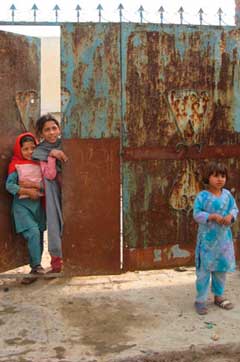 Children at the metal door of a home